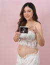 Pregnant woman showing ultrasound photo of baby Royalty Free Stock Photo