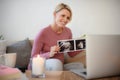 Pregnant woman showing ultrasound photo of her baby to webcam. Royalty Free Stock Photo