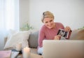 Pregnant woman showing ultrasound photo of her baby to webcam. Royalty Free Stock Photo