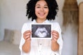 pregnant woman showing ultrasound photo her unborn baby Royalty Free Stock Photo