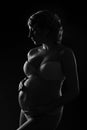 Pregnant woman silhouette over black background. Side view. Royalty Free Stock Photo