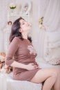 Pregnant woman sitting on a bed Royalty Free Stock Photo
