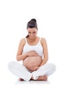 Pregnant woman sitting and practicing yoga