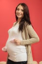 Pregnant woman with small shoes for unborn baby