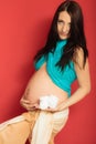 Pregnant woman with small shoes for unborn baby Royalty Free Stock Photo