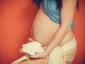 Pregnant woman with small shoes for unborn baby Royalty Free Stock Photo