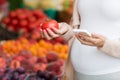 Pregnant woman with smartphone at street market Royalty Free Stock Photo