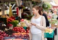 Pregnant woman with smartphone at street market Royalty Free Stock Photo