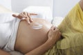 Pregnant Woman Smearing Lotion On Belly