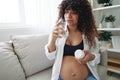 Pregnant woman smile and happiness taking pills and vitamins for pregnant women with pills hand water drinks clean water