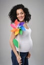 Pregnant woman with multicolored pinwheel windmill Royalty Free Stock Photo