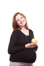 Pregnant woman smiling to the camera while holding an apple in her hands Royalty Free Stock Photo