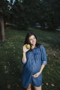 Pregnant woman snacking healthy with green apple