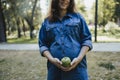 Pregnant woman snacking healthy with green apple