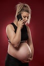 Pregnant woman speaking on phone Royalty Free Stock Photo