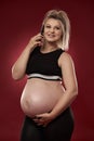 Pregnant woman speaking on phone Royalty Free Stock Photo