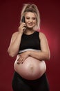 Pregnant woman speaking on phone Royalty Free Stock Photo