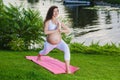 Pregnant woman doing prenatal yoga on nature. Royalty Free Stock Photo