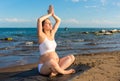 Pregnant woman in sports bra doing exercise in relaxation on yoga pose Royalty Free Stock Photo