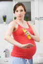 Pregnant Woman Spraying Mosquito Repellant To Protect Against Zika Virus Royalty Free Stock Photo