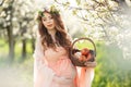 A pregnant woman in a spring garden with basket Royalty Free Stock Photo