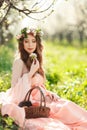 A pregnant woman in a spring garden with basket Royalty Free Stock Photo