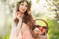 A pregnant woman in a spring garden with basket Royalty Free Stock Photo