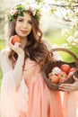 A pregnant woman in a spring garden with basket Royalty Free Stock Photo