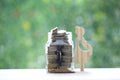 Pregnant woman with stack of coins money in glass bottle on natural green background,Save money for prepare in future and newborn Royalty Free Stock Photo