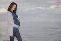 Pregnant Woman Standing Against Ocean Royalty Free Stock Photo