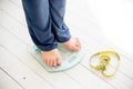 Pregnant woman standing on scales to control weight gain Royalty Free Stock Photo