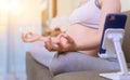 Pregnant woman stay at home alone. Pregnancy online learning for yoga and workout. Healthy