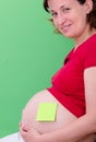 Pregnant woman with stick notes on her belly Royalty Free Stock Photo