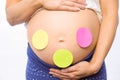 Pregnant woman with stickers on bump