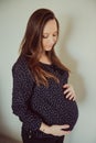 Pregnant woman sticks behind belly