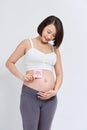 Pregnant woman with a sticky note saying Girl on her belly. on white background