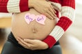 Pregnant woman with a sticky note and writing love boy or girl on sticky note and add on her belly Royalty Free Stock Photo