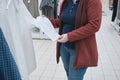 Pregnant woman in the store chooses a new white business shirt for her husband Royalty Free Stock Photo