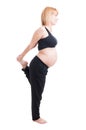 Pregnant woman stretching legs standing in one leg Royalty Free Stock Photo