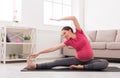 Pregnant woman stretching training indoors Royalty Free Stock Photo