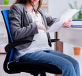 Pregnant woman struggling with pain in office