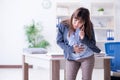 The pregnant woman struggling to do work in office Royalty Free Stock Photo