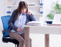 Pregnant woman struggling to do work in office Royalty Free Stock Photo