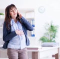 Pregnant woman struggling to do work in office Royalty Free Stock Photo