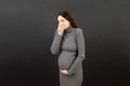 Pregnant woman suffering from toxicosis. Toxicosis Of Pregnancy. Pregnant Lady Feeling Sick Having Nausea Standing On Royalty Free Stock Photo