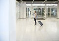 Pregnant woman with suitcase at airport or station
