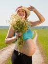 Pregnant woman on summer road Royalty Free Stock Photo