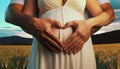 pregnant woman at sunset with man making heart from hands Royalty Free Stock Photo