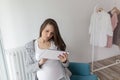 Pregnant woman surfing the new on tablet computer Royalty Free Stock Photo