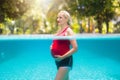 Pregnant woman in swimming pool. Healthy pregnancy Royalty Free Stock Photo